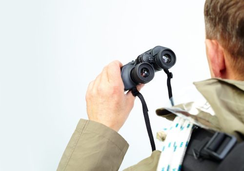 close-up-man-holding-binoculars-scaled.jpg